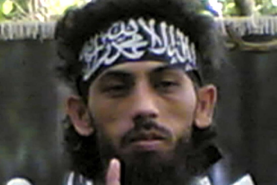 File photo obtained by the Associated Press from a Philippine security official showing Indonesian militant Umar Patek, a key suspect in the 2002 Bali bombings that killed 202 people, addresses fellow militants in an Abu Sayyaf mountain encampment on Jolo island in the southern Philippines. Photo: AP
