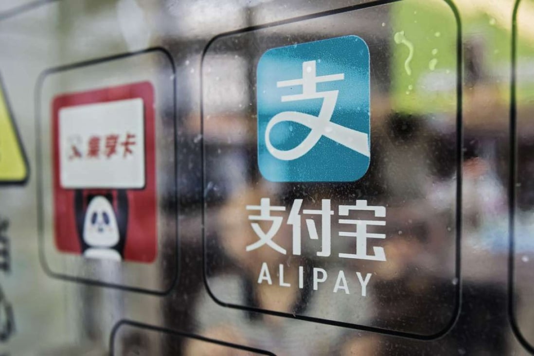 Signage for Ant Financial Services Group's Alipay payment system, an affiliate of Alibaba Group Holding Ltd., is displayed on a store entrance in Shanghai, China. Photo: Bloomberg