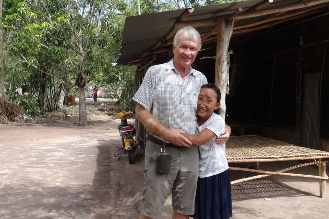 Chantrea, who had a meningoencephalocele (MEC), was trafficked as a beggar before being spotted by Jock Struthers at Cambodia’s border with Vietnam, in 2012. She is seen here with Struthers, in June 2016, at her family’s home. Pictures: courtesy of Jock Struthers and the Children’s Surgical Centre