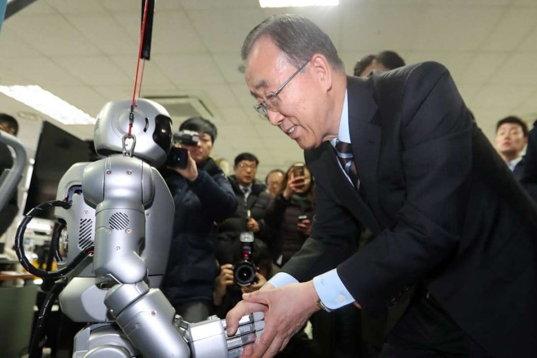 Former UN secretary general Ban Ki-moon shakes hands with Hubo, a humanoid robot, during his visit to the Korea Advanced Institute of Science and Technology. Photo: EPA