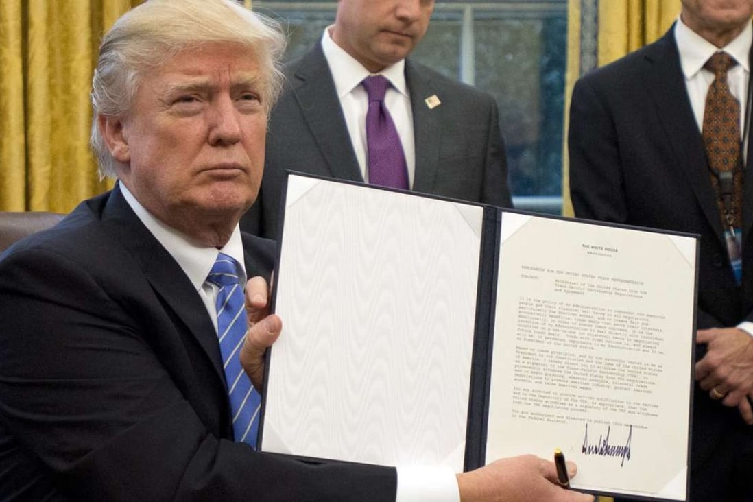 US President Donald Trump shows the Executive Order withdrawing the US from the Trans-Pacific Partnership (TPP). Photo: EPA