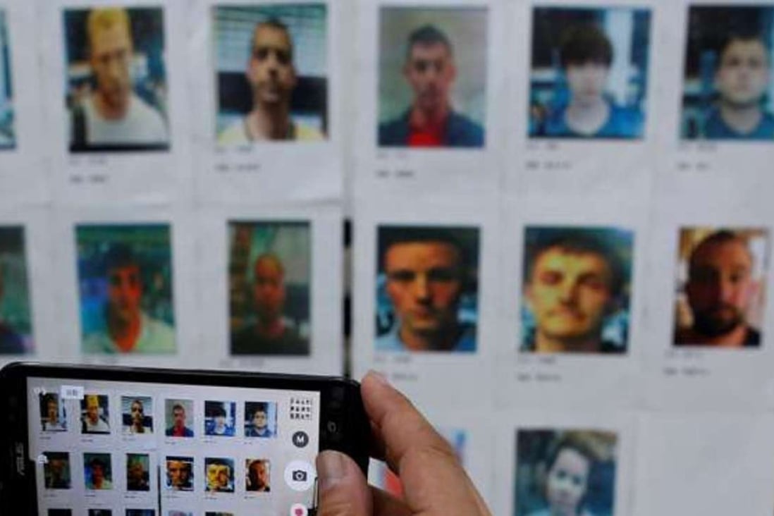 A journalist takes a photo of some of the suspects in the case. Photo: Reuters.