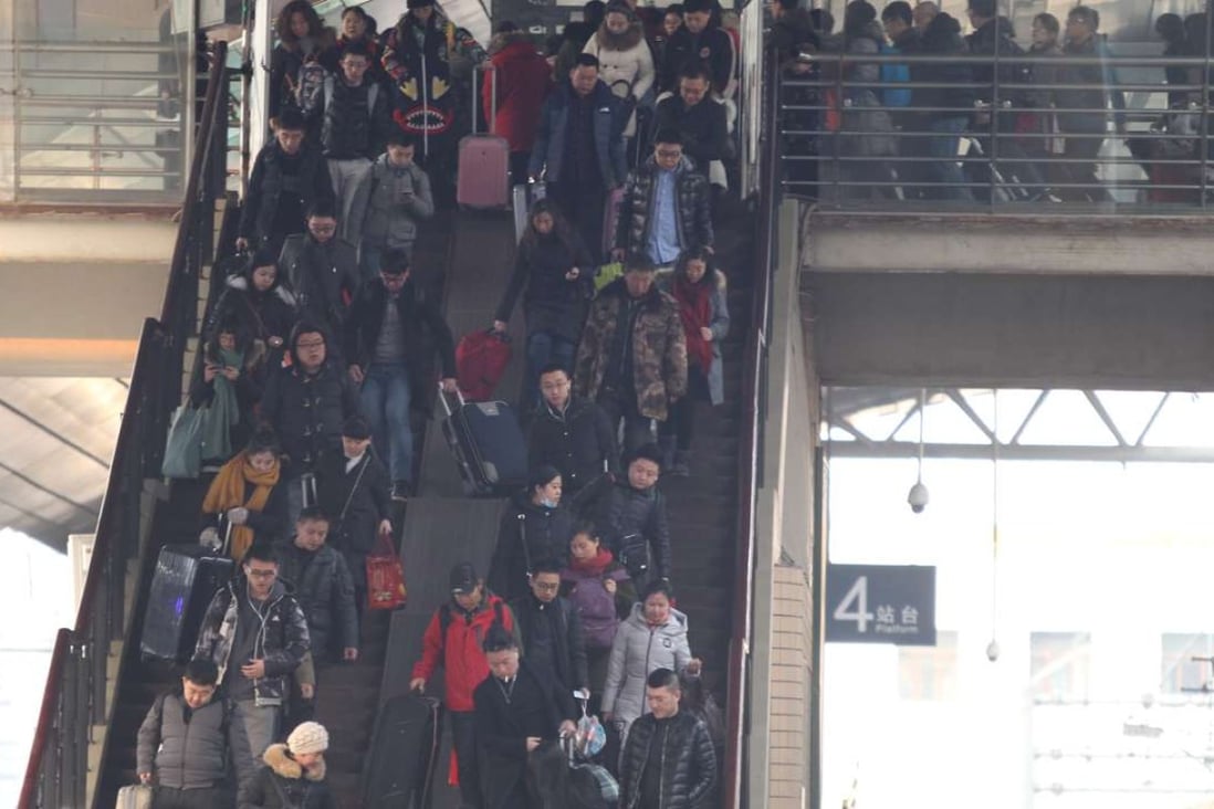 Holiday travellers at the Beijing Railway Station on January 25. Photo: Simon Song