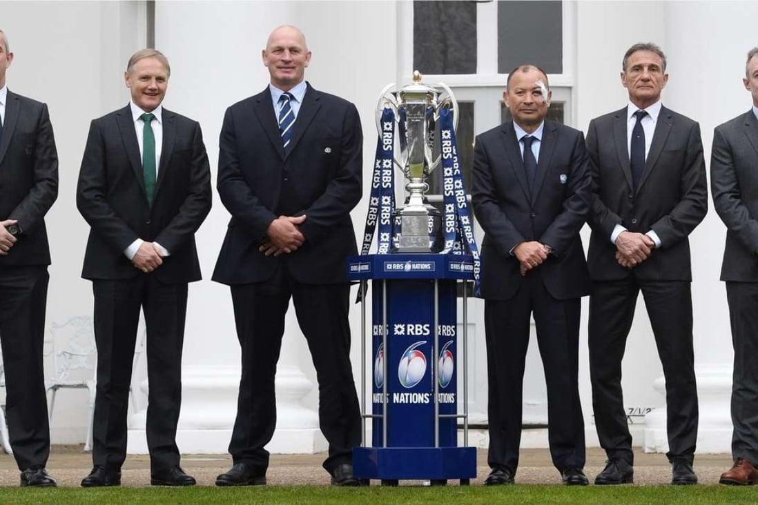 The head coaches of Italy, Ireland, Scotland, England, France and Wales pose with the Six Nations trophy. Photo: EPA