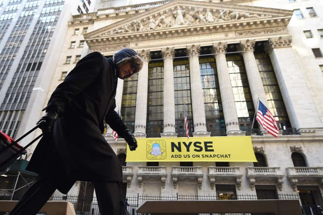 A person walks past the New York Stock Exchange on Wall Street in New York. Wall Street stocks retreated, joining other major markets that have fallen after President Donald Trump's controversial ban on people from seven predominantly Muslim countries entering the United States. Photo: AFP