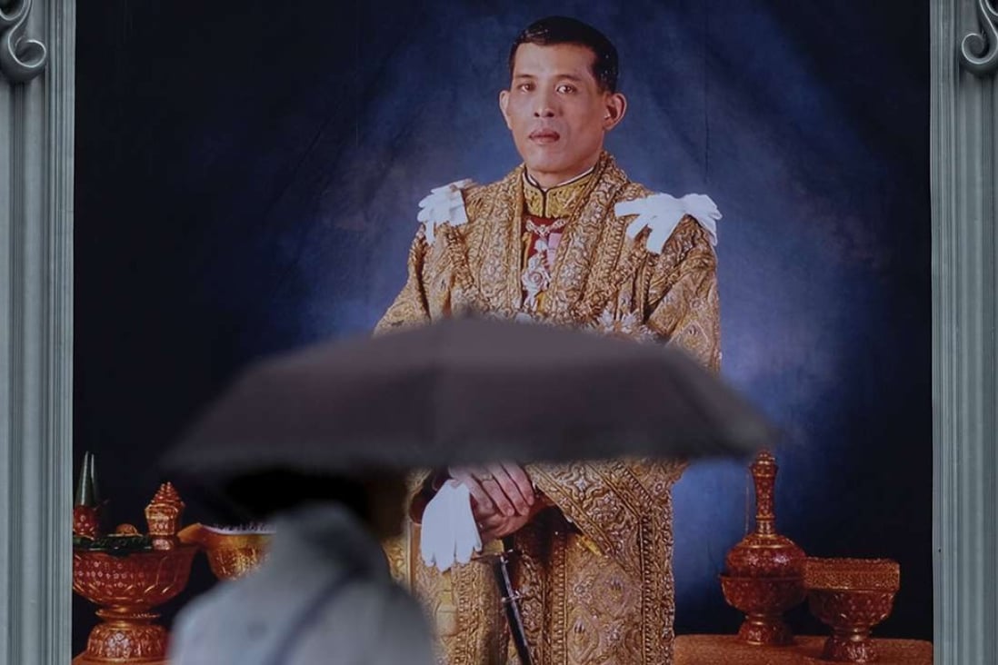 A woman walks past a portrait of Thailand's King Maha Vajiralongkorn Bodindradebayavarangkun. Photo: Reuters