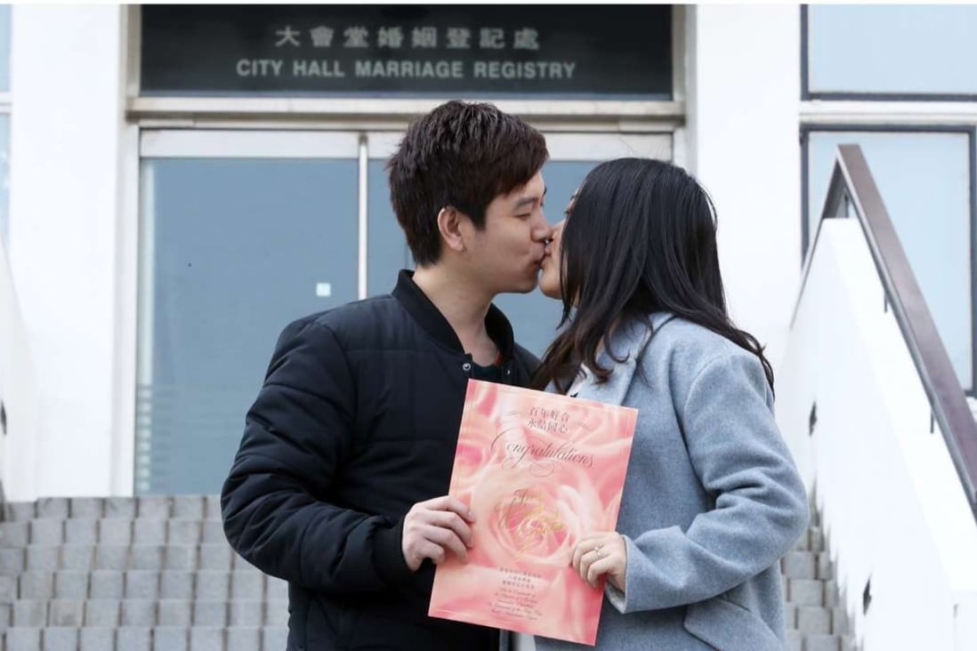 Huang Ziyue gives Ann Lam a Valentine’s Day kiss after getting married at City Hall. Photo: Edward Wong