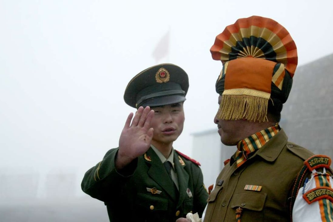 A Chinese soldier and an Indian counterpart on the Chinese side of the ancient Nathu La border crossing between India and China. Photo: AFP