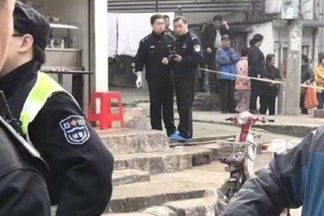 Police attend the noodle store in Wuhan where the owner was beheaded by a customer. Photo: Handout