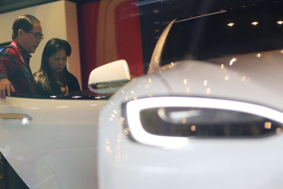 Potential buyers visit the showroom of electric carmaker Tesla in Wan Chai. Photo: Dickson Lee