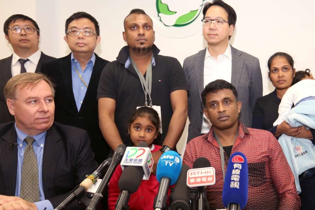 The asylum seekers with their lawyer Robert Tibbo (front, left), and legislators Charles Mok (back, second right) and James To (back, second left). Photo: Xiaomei Chen