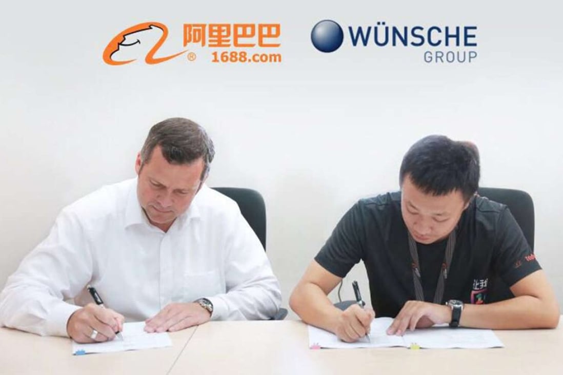 Andre Zuppa (left), managing director of Wünsche Food, signs an agreement with Alibaba