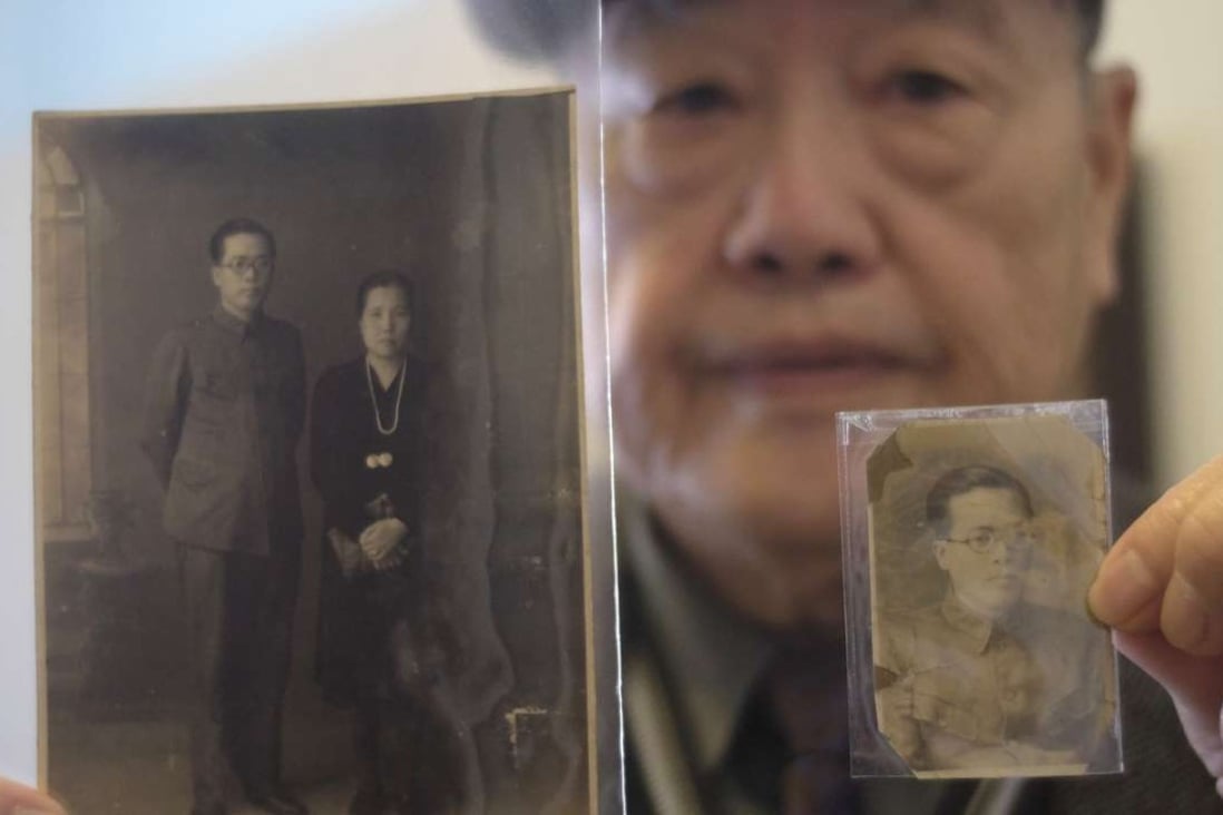 Pan Hsin-hsing displays pictures of his parents during an interview in Taipei. He was just six when his father, Pan Mu-chih, a doctor and local politician, was arrested, tortured and killed in the “228 Incident” that was followed by the “White Terror” purges. Photo: AFP