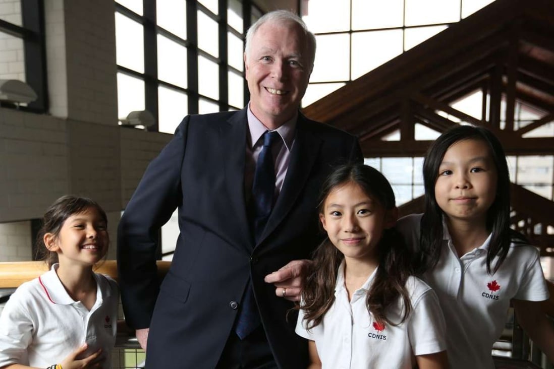 Canadian International School interim headmaster David Baird with pupils (from left) Moorea Plested, Danica Yeung and Stephanie Su at the school in Wong Chuk Hang. Photo: Xiaomei Chen
