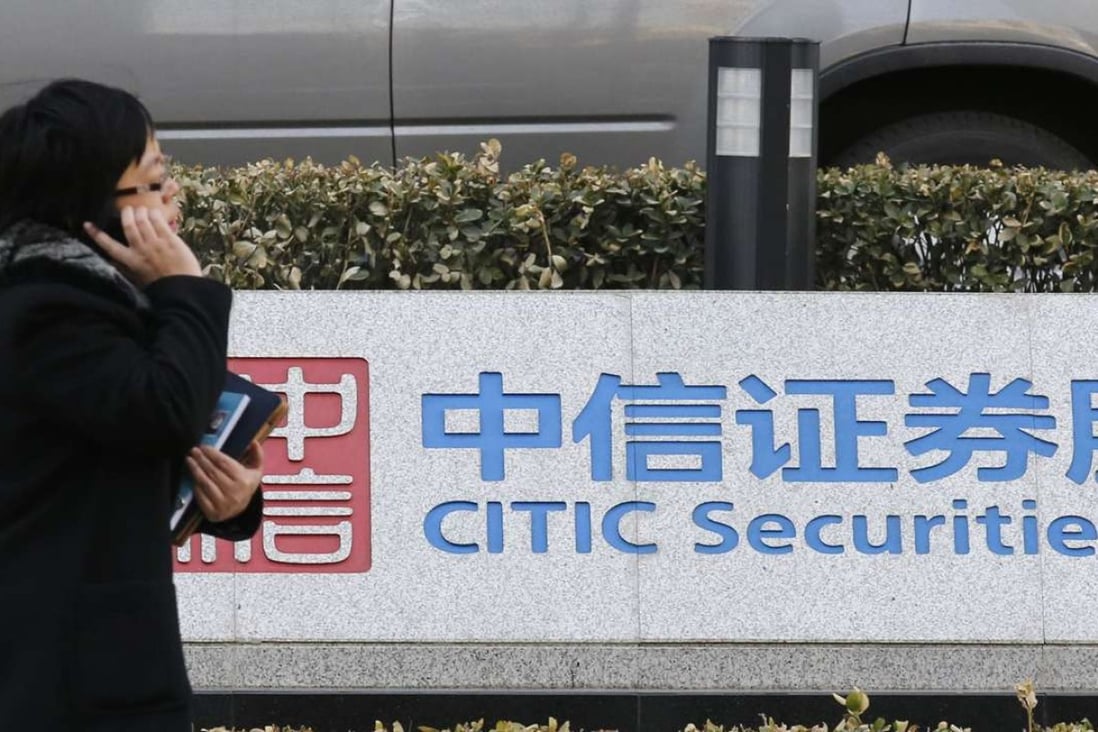A woman walks past a signboard of CITIC Securities at its head office in Beijing March 27, 2013. Wang Dongming, chairman of China's biggest brokerage CITIC Securities Co Ltd, was so impressed by the Charles Ellis bestseller "The Making of Goldman Sachs" that he called for a Chinese translation and urged his employees to read it. Wang is now busy remodelling his Beijing-based brokerage after Goldman Sachs Group Inc by expanding into asset management, trading complex derivatives instruments and nurturing overseas businesses. REUTERS/Kim Kyung-Hoon (CHINA - Tags: BUSINESS)