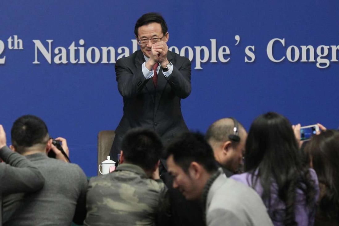 CSRC chairman Liu Shiyu greets the press at the National People’s Congress media centre in Beijing in March last year. Photo: