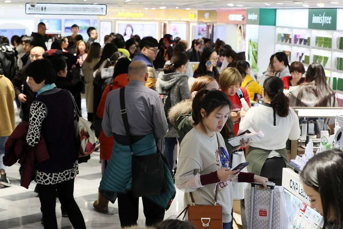 Chinese shoppers crowd a Lotte Duty Free shop in downtown Seoul. The company has a major presence in China, where there has been a backlash against it. Photo: EPA
