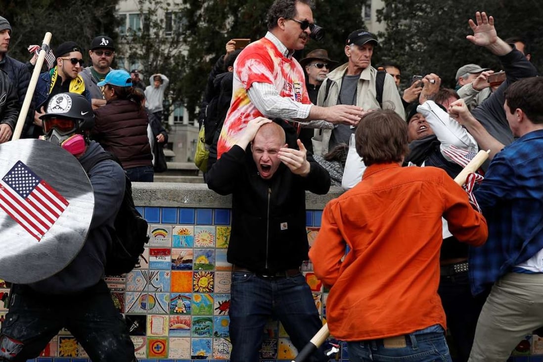 A demonstrator supporting US President Donald Trump (L) holds a shield as a group of men punch a counter demonstrator during a ‘People 4 Trump’ rally in Berkeley, California. Photo: Reuters