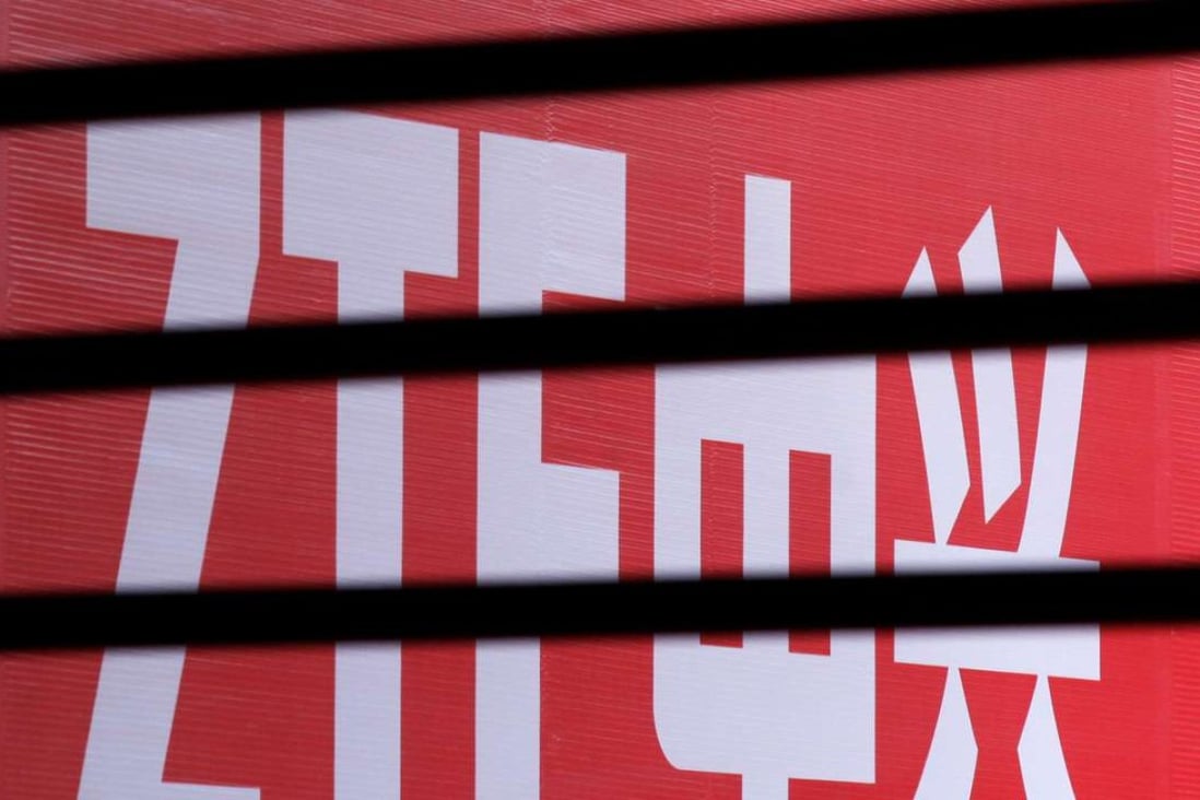 The company logo of ZTE is seen through a wooden fence on a glass door during the company's 15th anniversary celebration in Beijing in 2013. The company has agreed to pay a record fine to the US for violating sanctions against Iran and North Korea. Photo: Reuters