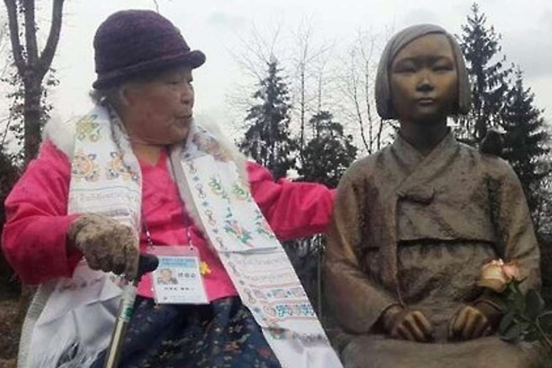 Ahn Jeom-soon, a 90-year old former South Korean comfort women, sits next to a statue in memory of the comfort women in Wiesent, Germany, on Wednesday. Photo: Yonhap News