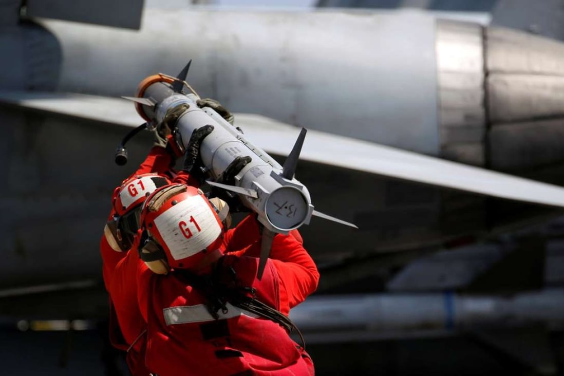 US Navy personnel carry a missile to arm an F-18 fighter jet on the deck of the USS Carl Vinson during a routine exercise in the South China Sea earlier this month. Photo: Reuters