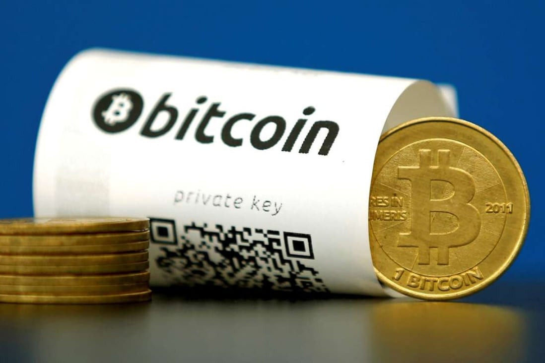 A Bitcoin paper wallet with QR codes and a coin are seen in an illustration picture taken at La Maison du Bitcoin in Paris, France. Photo: Reuters