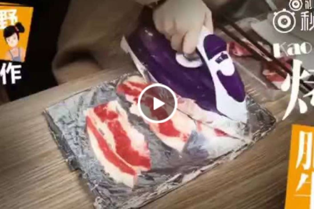 Little Ye grills beef on her office desk using a clothes iron. Photo: Handout