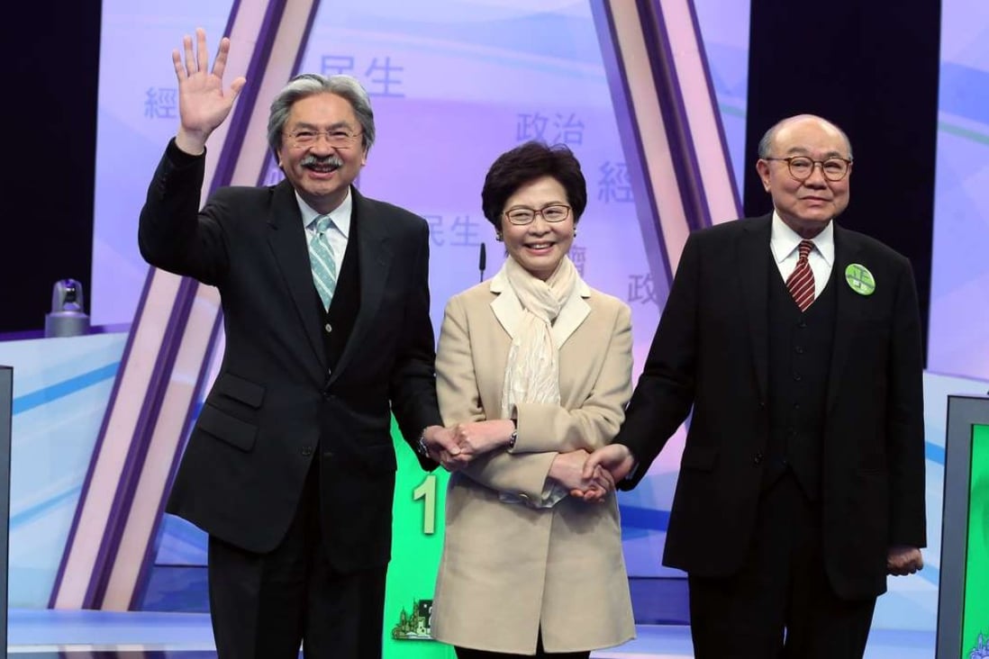 Chief executive candidates John Tsang, Carrie Lam and Woo Kwok-hing are all smiles at the start of the debate. Photo: K. Y. Cheng