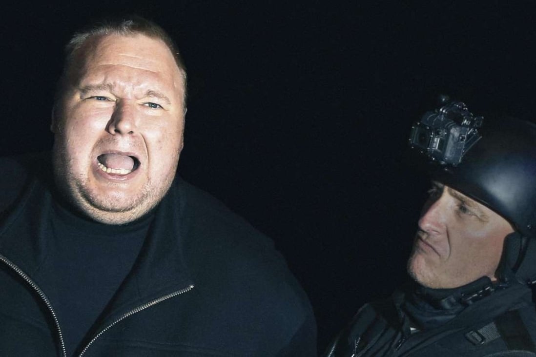 Kim Dotcom re-enacts the police raid on his house in New Zealand and his arrest on its first anniversary, in January 2013.