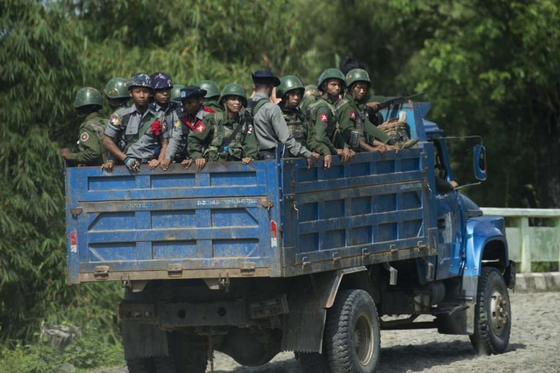 Armed military troops and police force travelling in trucks through Maungdaw, located in Rakhine State. File photo: AFP