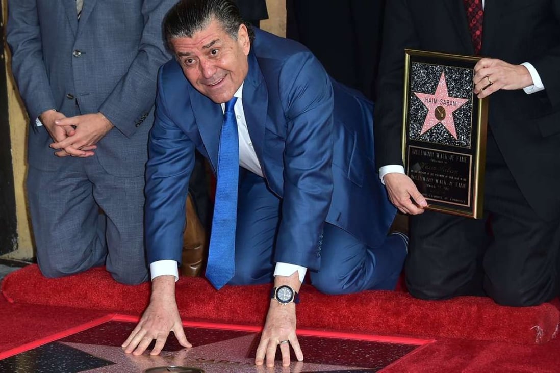Producer and Power Rangers creator Haim Saban touches his Hollywood Walk of Fame star on Wednesday. Photo: AFP