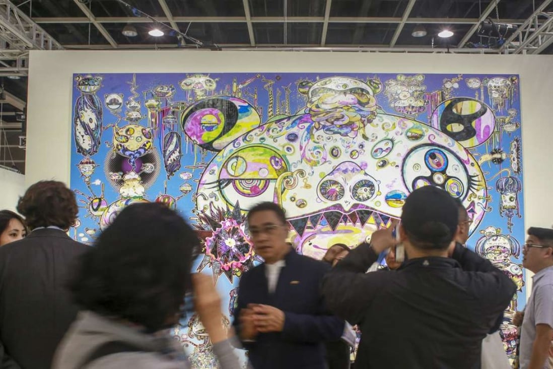 Visitors to Art Basel Hong Kong view a painting by Tan Tan Bo. Dealers report fewer collectors from China at the fair than last year. Photo: May Tse