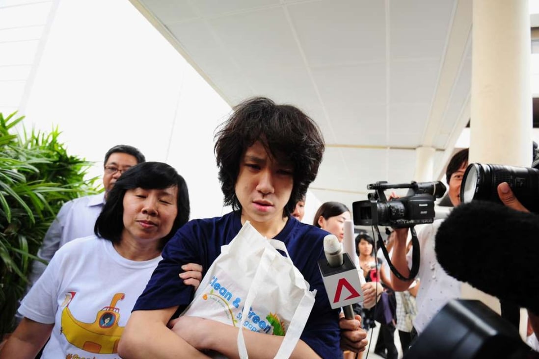 Singapore teenage blogger Amos Yee with his mother Mary Toh Ai Buay and father Alphonsus Yee, outside the state court in Singapore on July 6, 2015. Photo: AFP