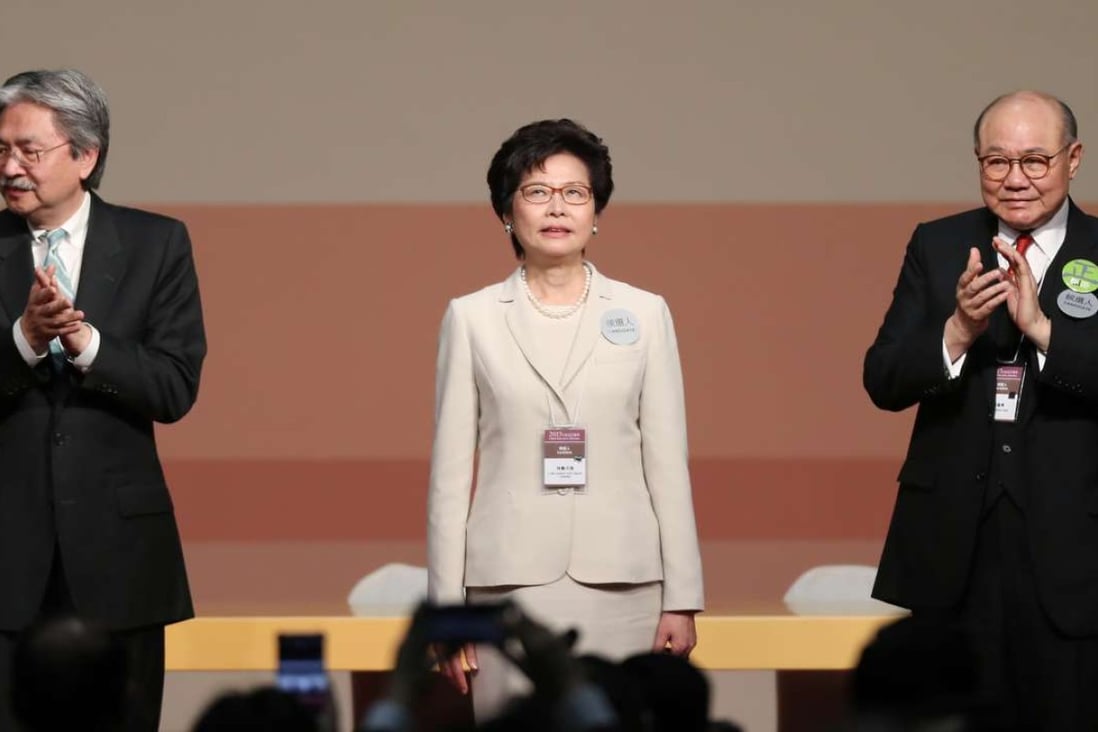 Carrie Lam is applauded by her defeated rivals, John Tsang (left) and Woo Kwok-hing. Photo: Robert Ng