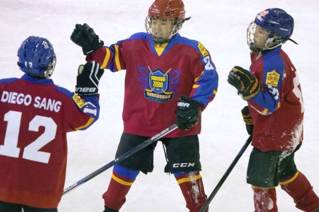Chinese players high-five each other during a youth ice hockey tournament in Beijing. The National Hockey League sees China as hockey’s next great frontier. Photo: AP