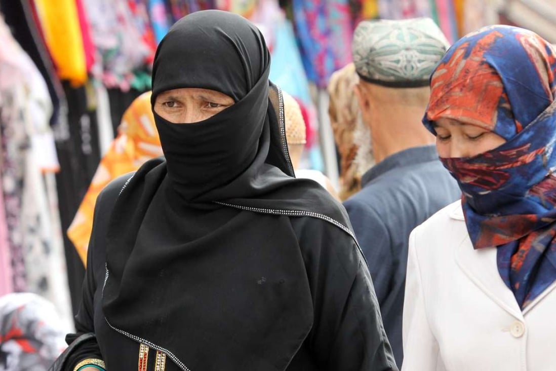 A file photo from 2011 shows women in Hotan, Xinjiang. The wearing of veils in the region has been banned. Photo: Edward Wong