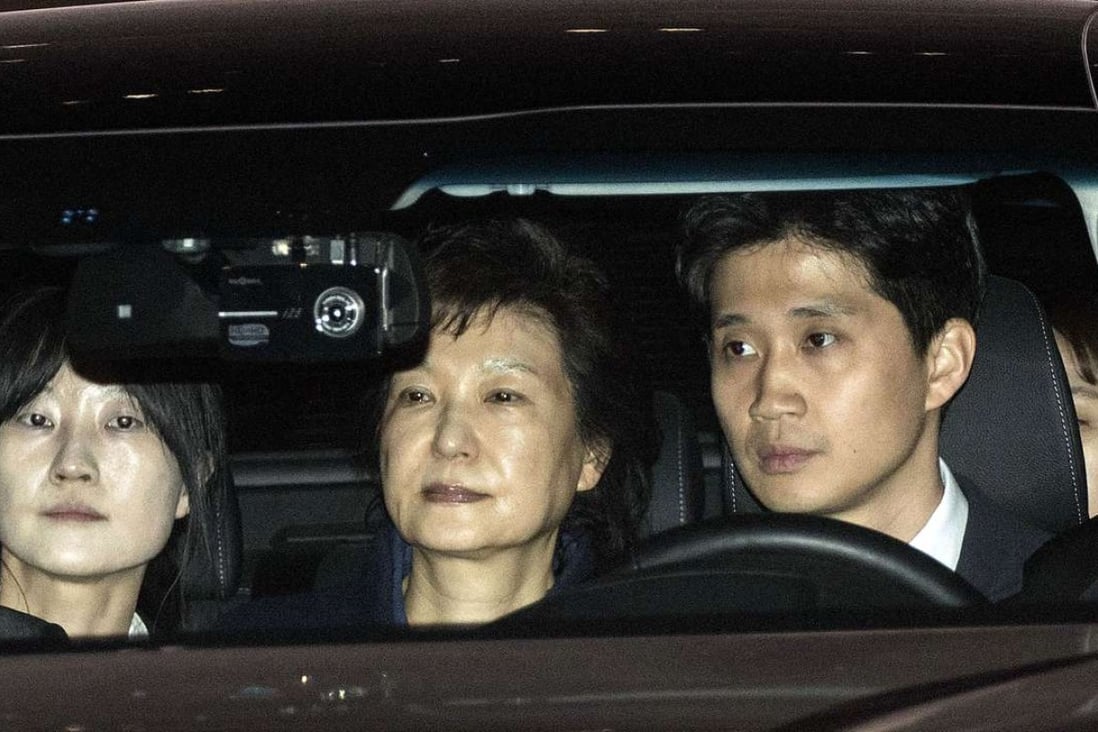 Park Geun-hye, former president of South Korea (centre) leaves the Seoul Central Prosecutors' Office early Friday. Photo: Bloomberg