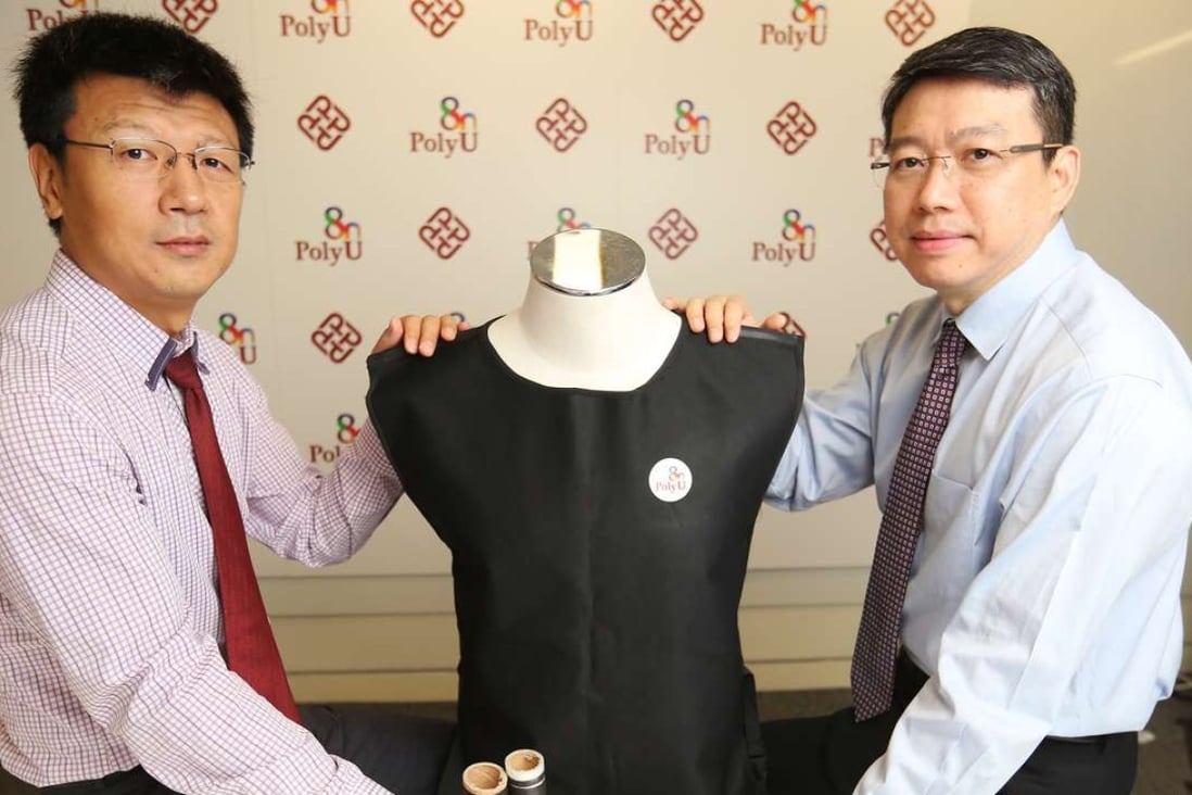Professor Fei Bin (left) and Professor John Xin Haozhong(Xin is family name) with their protective vest. Photo: Xiaomei Chen