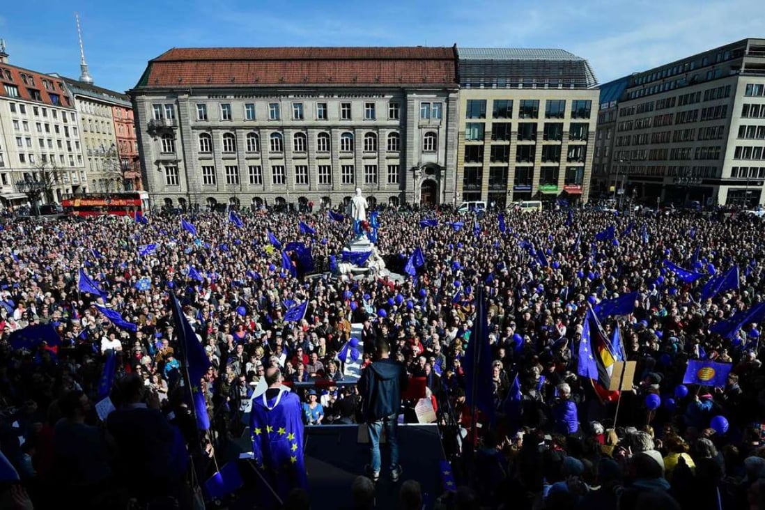 People attend a pro-Europe demonstration in Berlin on March 26. Contrary to last year’s theory that Britain would be the first of many dominos to fall out of the EU, the precise opposite is happening. Contemplating Britain’s predicament, continental voters are backing away from full-blown secession from Europe. Photo: AFP