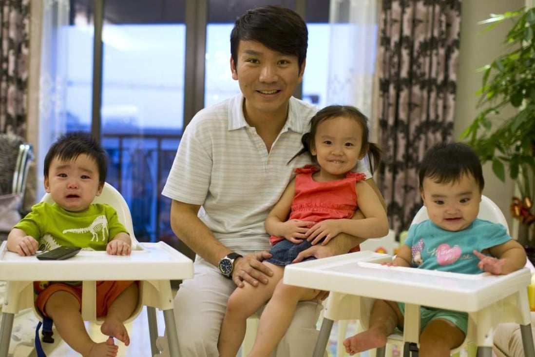 Shanghai businessman Tony Jiang with his three children, a daughter and twin boys, who were born to an American surrogate. Photo: Reuters