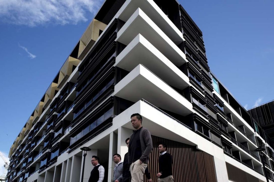 Sydney residents walk past a newly-completed apartment development in Sydney's inner-city suburb of Zetland. The country’s banking watchdog is keeping a close eye on the country’s red-hot housing market. Photo: Reuters