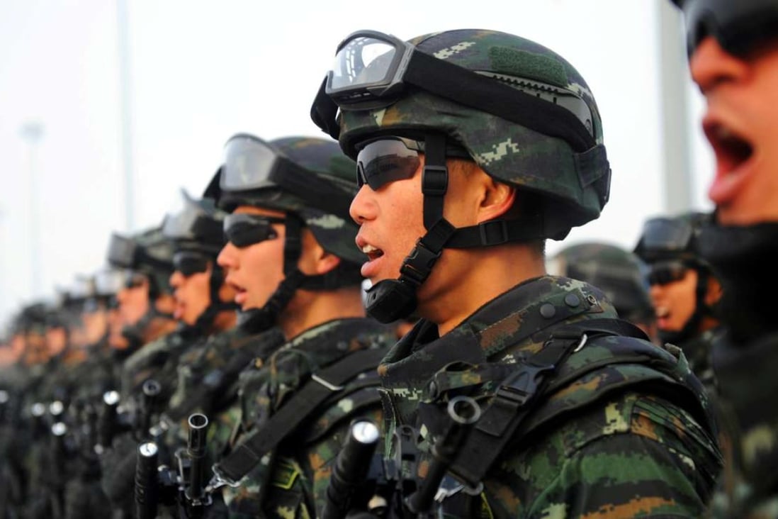 Paramilitary policemen taking part in an anti-terrorism rally in Kashgar in Xinjiang this February. Photo: Reuters
