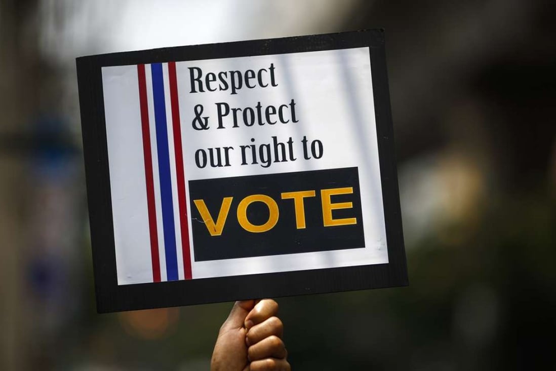 A man holds a placard during a rally demanding the right to vote be respected. File photo: Reuters
