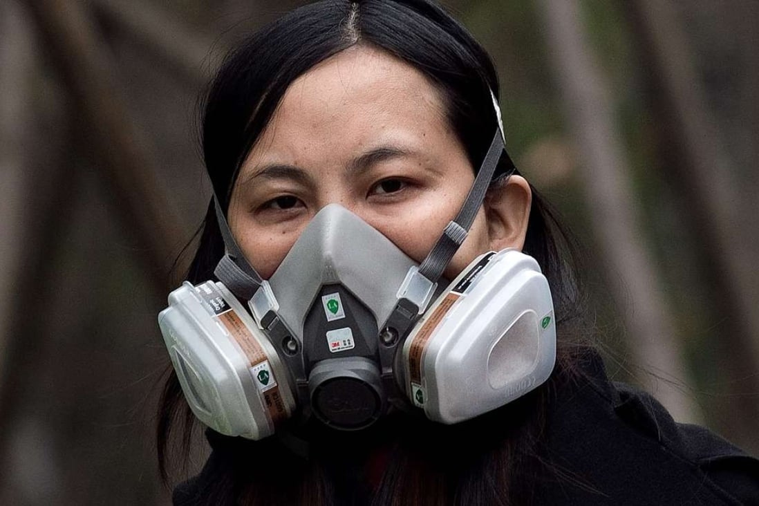 A woman wears a protective mask on a street in Beijing in March. Photo: AFP