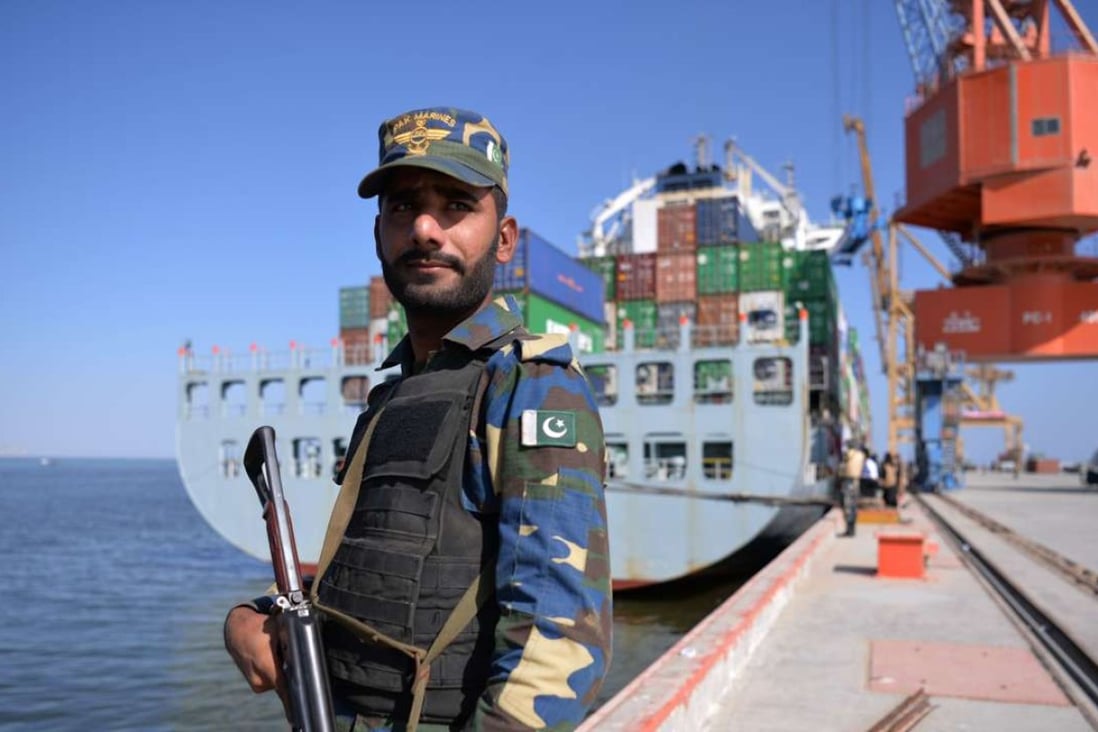 A Pakistani naval personnel stands guard beside a ship carrying containers during the opening of a trade project in Gwadar port, some 700km west of Karachi. The port is a key component of a trade route linking the Gwadar to the Chinese city of Kashgar. Photo: AFP