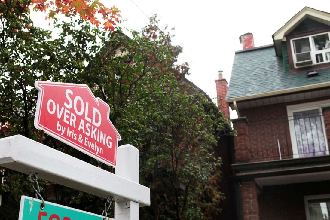 A sold sign is on display outside a house in Toronto, where the red-hot housing market rose more than 30 per cent last year. Photo: Reuters