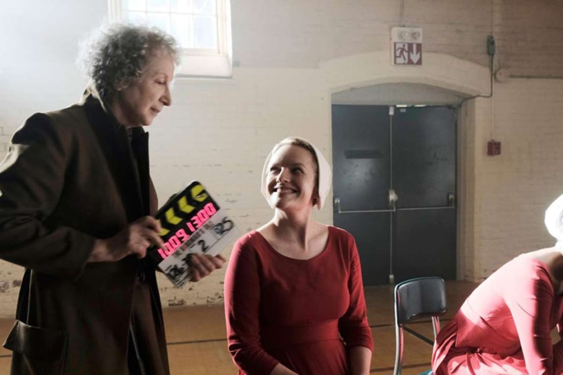Margaret Atwood (left) was consulted on, and has a cameo role in Hulu's adaptation of her novel The Handmaid's Tale, which stars Elisabeth Moss (centre) as “handmaid” Offred. Photo: Hulu