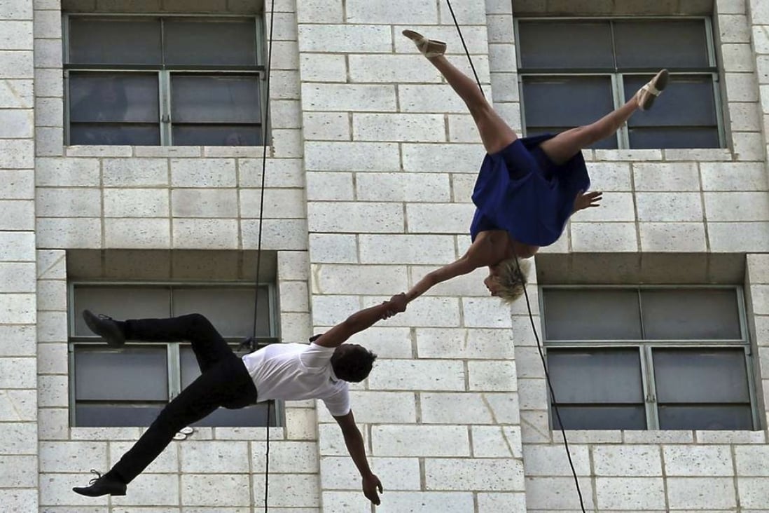Dancers from Bandaloop aerial dance troupe perform to a medley of songs from the movie "La La Land" off the side of Los Angeles City Hall, during "La La Land Day" festivities Tuesday, April 25, 2017. Photo: AP
