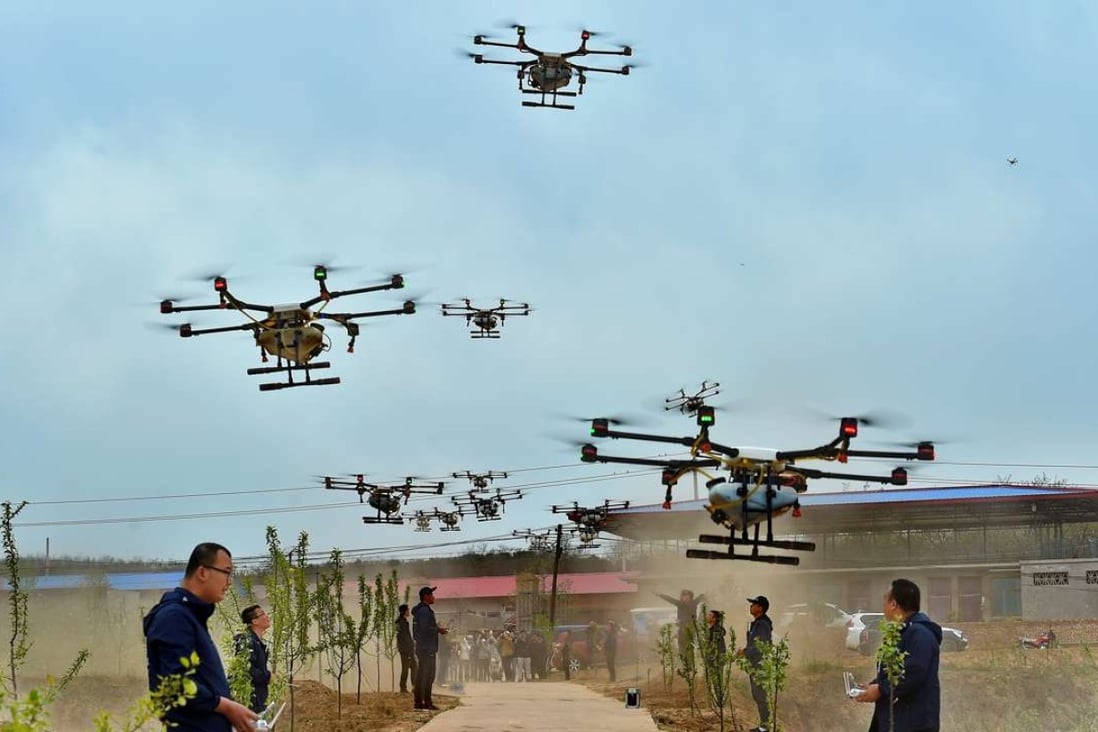 Drone operators launch their machines to spray an orchard in Ji county, Shanxi province. One orchardist said the drones could perform the task 15 times faster than a farm labourer. Photo: Xinhua
