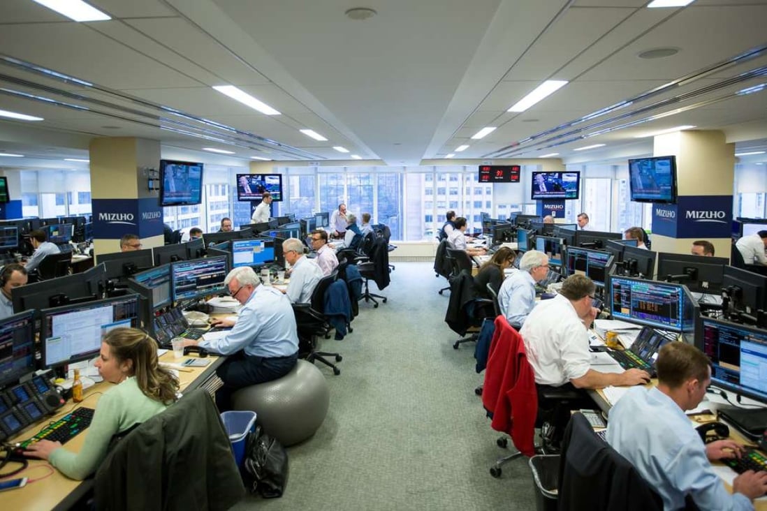 Glass-Steagall regulation, repealed in 1999, would not have prevented or ameliorated the global systemic collapse in 2008. Traders work on the Mizuho Americas trading floor in New York. Photo: Bloomberg